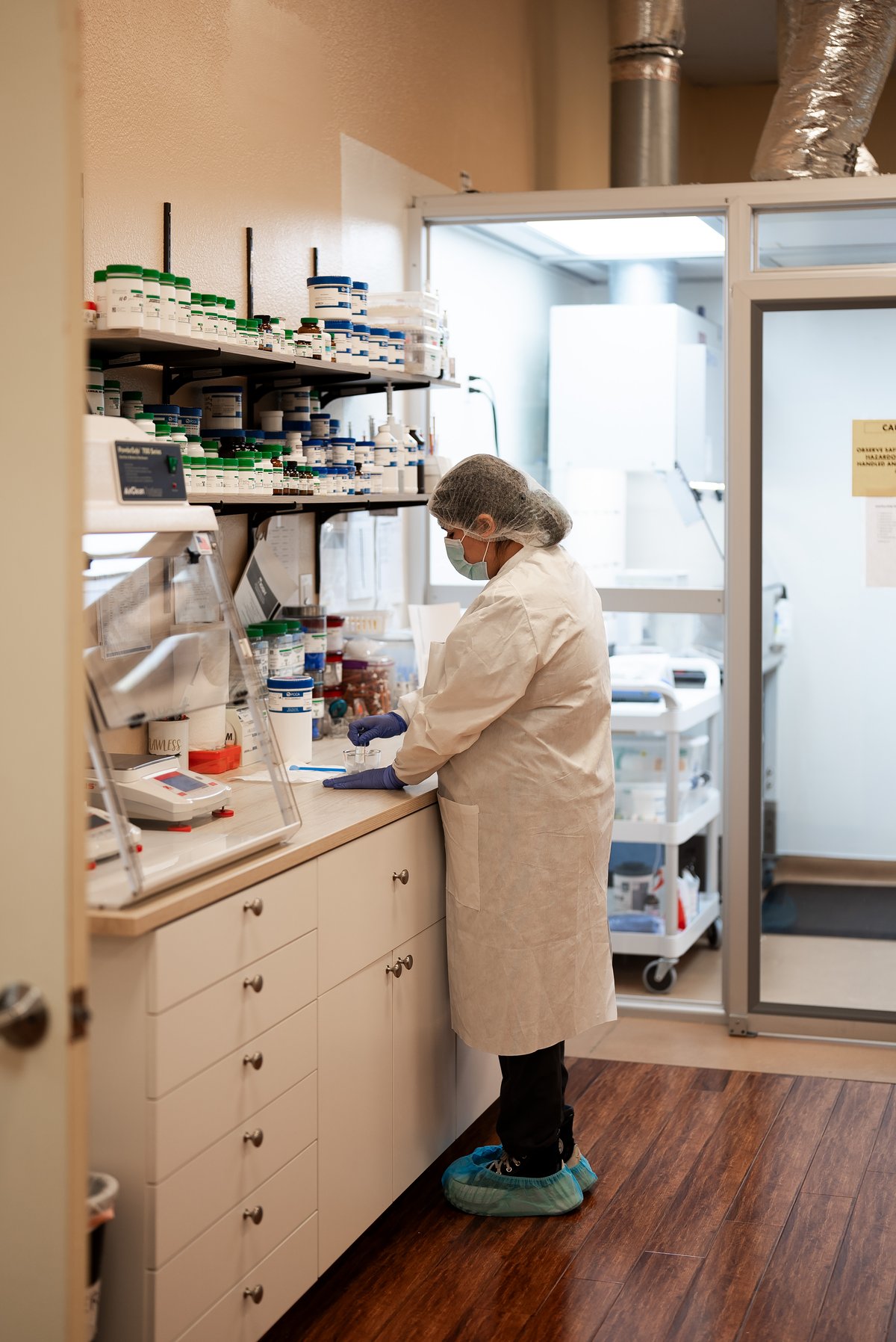 Pharmacist compounding medication in TFC's USP-compliant lab